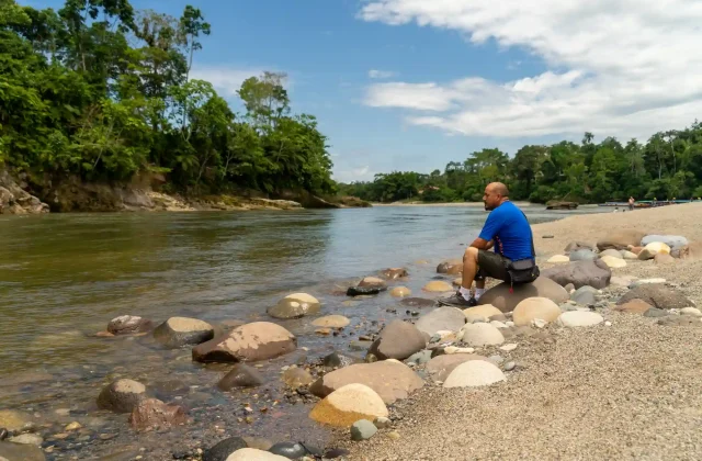 single-man-sitting-edge-river-amazon-jungle-ecuador